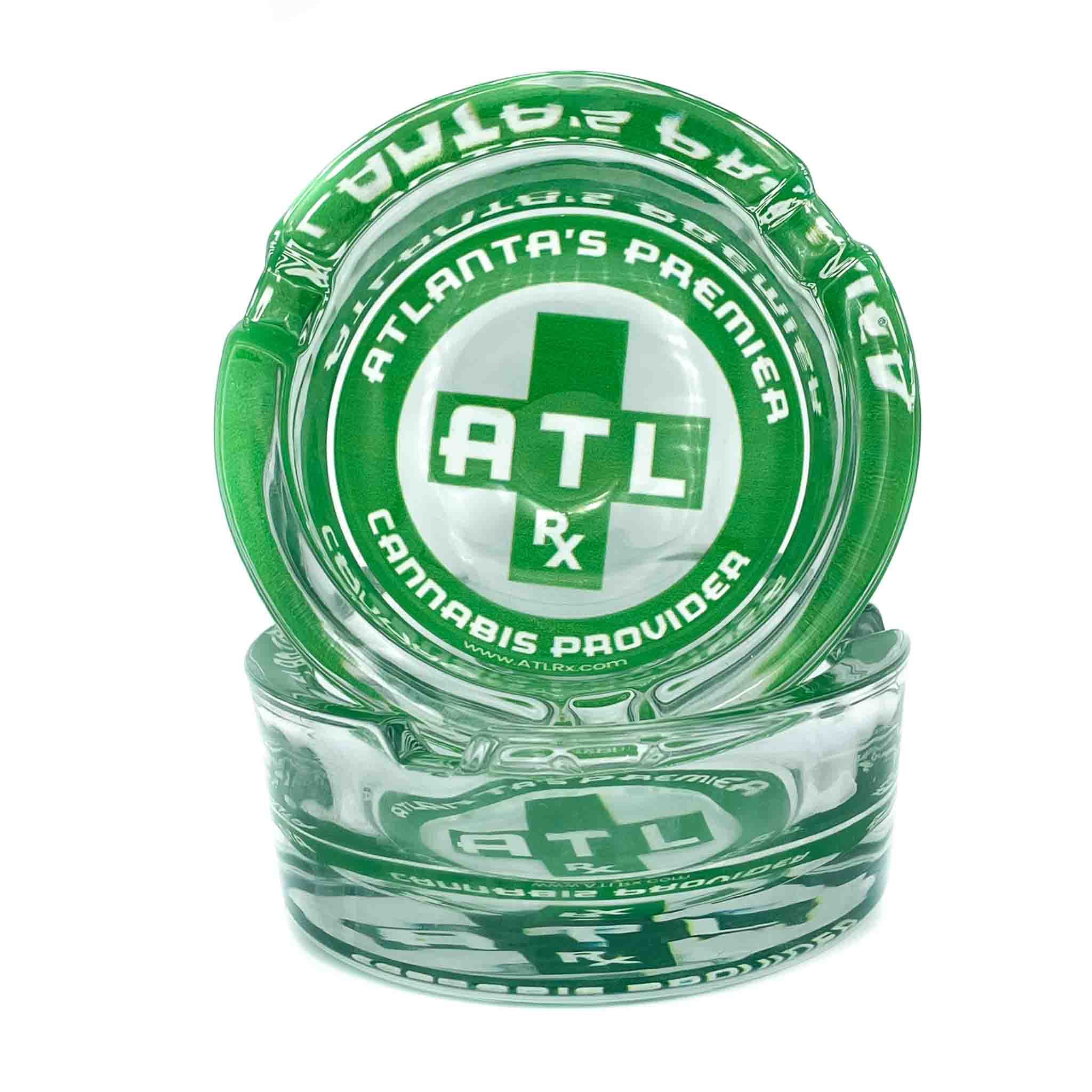 Clear glass ashtray with the green ATLRx logo
