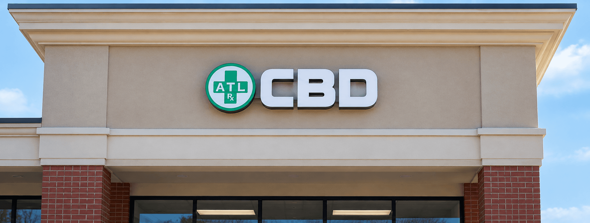 An illuminated ATLRx CBD sign above the entrance to an ATLRx store